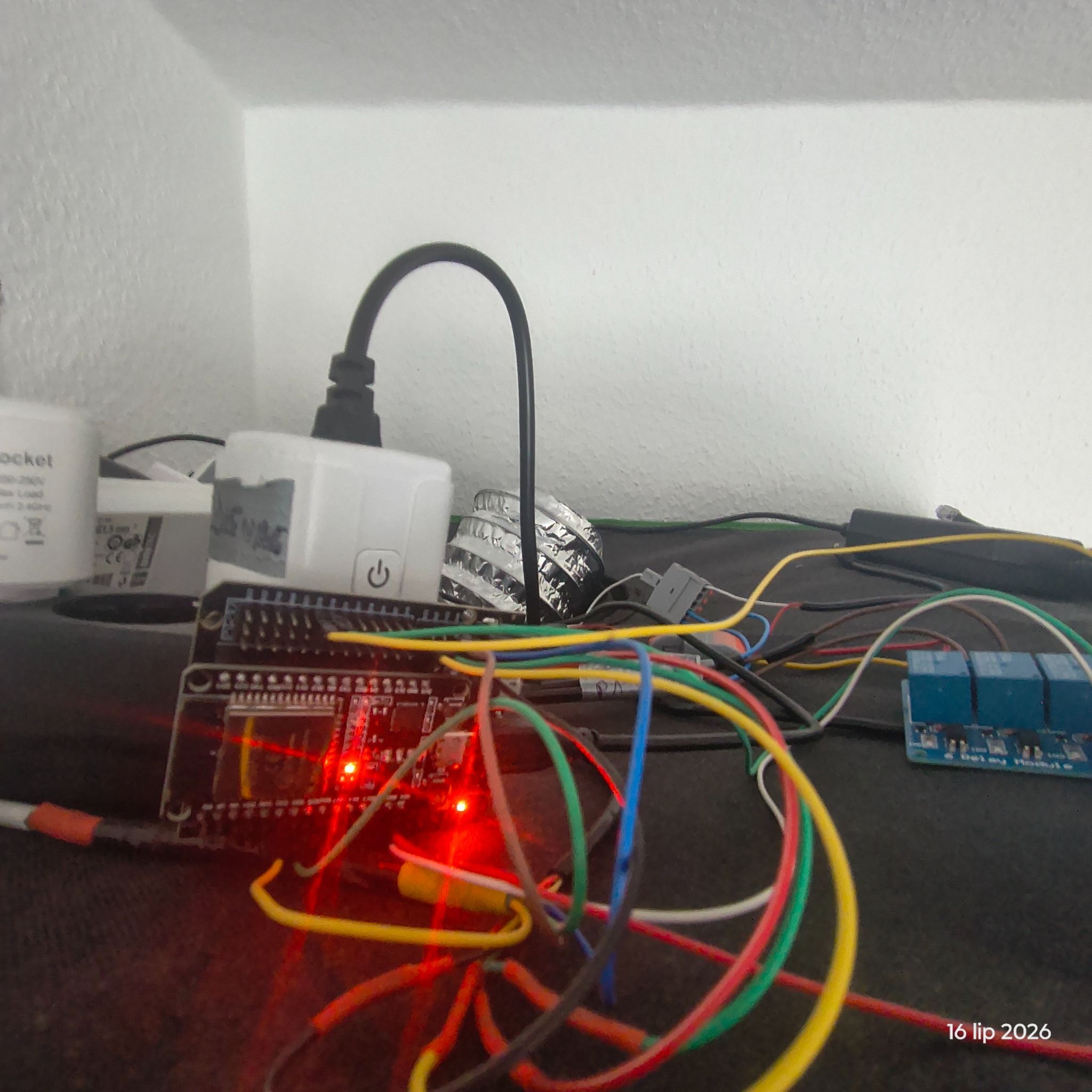 ESP32 sensor node and relay hardware installed on top of a grow tent